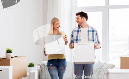 Image of happy couple with boxes moving to new home