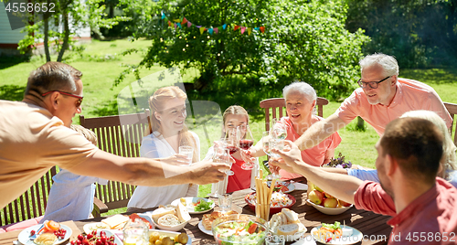 Image of happy family having dinner or summer garden party