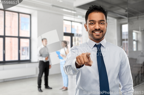 Image of businessman pointing to you over people in office