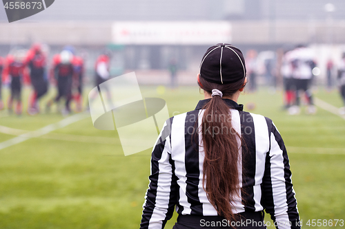 Image of rear view of female american football referee