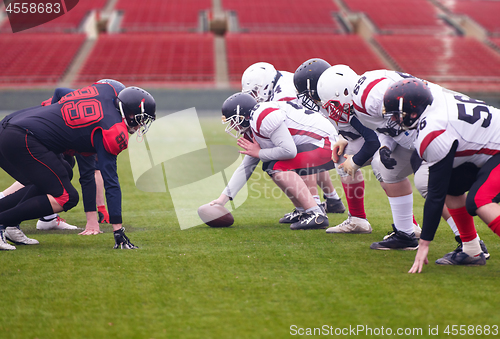 Image of professional american football players ready to start