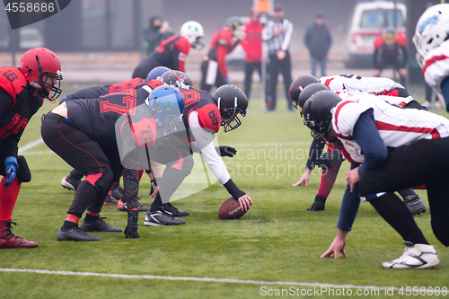 Image of professional american football players ready to start