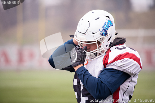 Image of portrait of young confident American football player