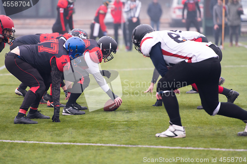 Image of professional american football players ready to start