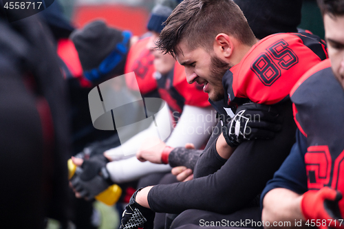 Image of american football player holding the injured shoulder