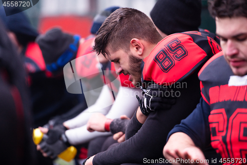 Image of american football player holding the injured shoulder