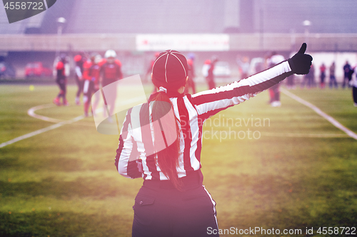 Image of rear view of female american football referee