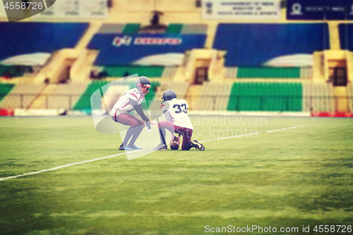 Image of american football players practicing football kickoff