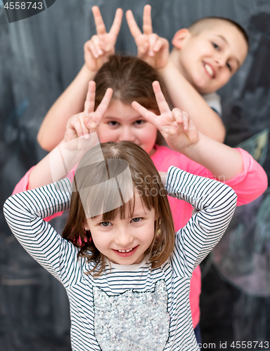 Image of group of kids standing in front of chalkboard