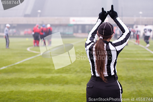 Image of rear view of female american football referee