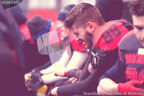 Image of american football player holding the injured shoulder