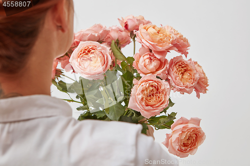 Image of Bouquet of beautiful roses in the hands of a girl