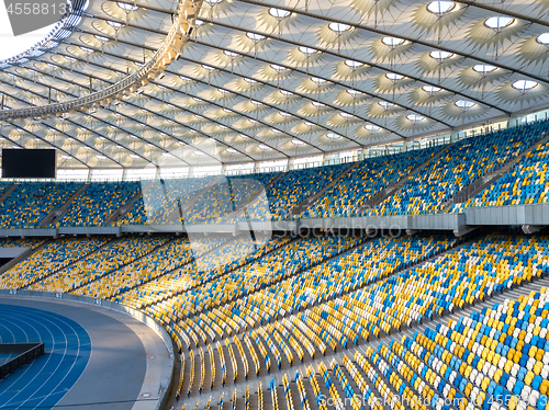 Image of KYIV, UKRAINE - July 19, 2018. Panoramic view of construction of the stadium roof, tribunes with yellow and blue seats of NSC Olimpiysky.