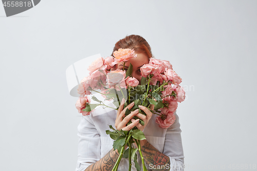 Image of Bouquet of beautiful roses in the hands of a girl