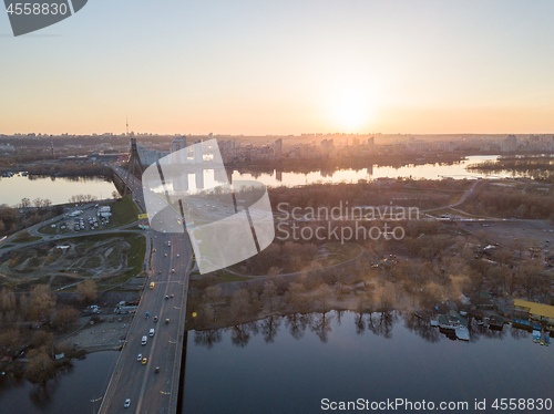 Image of North bridge over the Dnieper River overlooking the Skaimol shopping center and Obolon district on the sunset