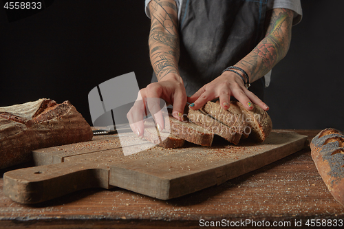 Image of Baker Holds Bran Bread