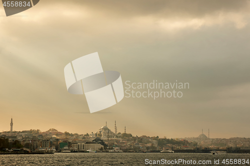 Image of Panoramic view of the sunset in the rays of the sun on the dramatic rain sky of Istanbul, Turkey