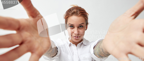 Image of Young woman smiling with her arms open on white background