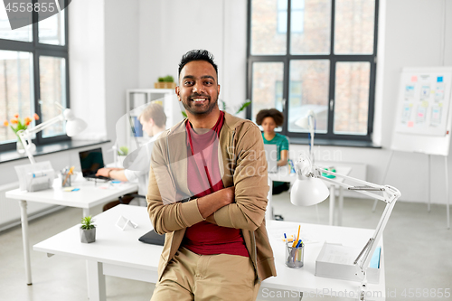 Image of smiling indian man at office