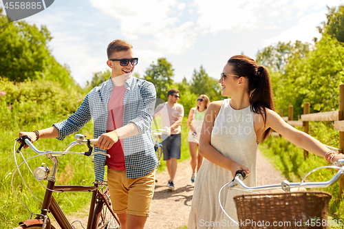 Image of happy couple with bicycles at summer park