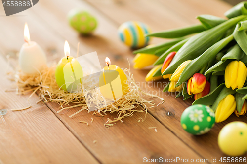 Image of candles in shape of easter eggs and tulip flowers