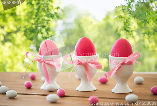 Image of easter eggs in holders and candies on table