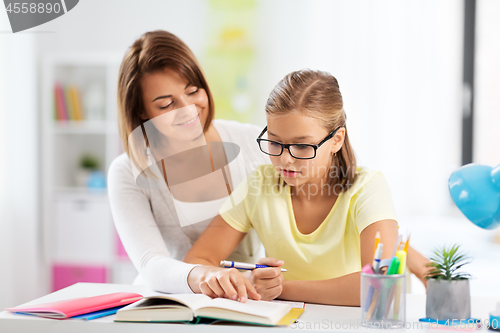 Image of mother and daughter doing homework together