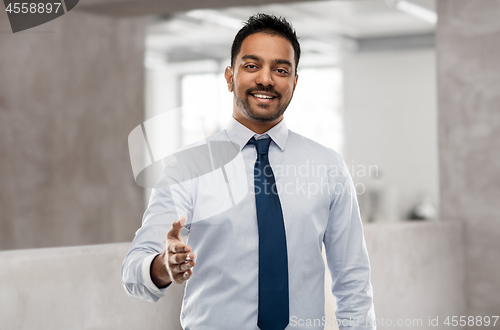 Image of indian businessman stretching hand for handshake