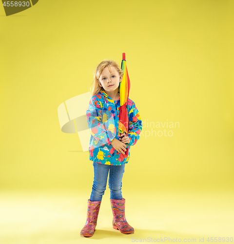 Image of A full length portrait of a bright fashionable girl in a raincoat