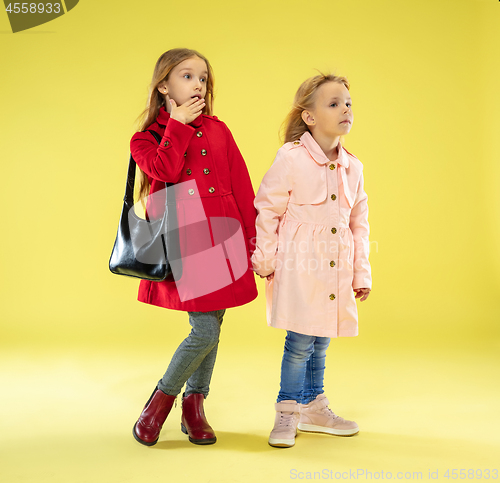 Image of A full length portrait of a bright fashionable girls in a raincoat