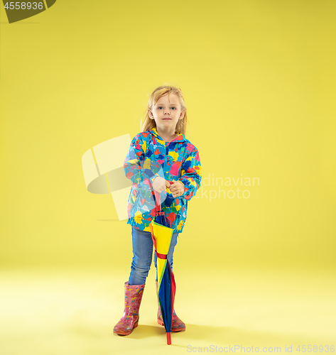 Image of A full length portrait of a bright fashionable girl in a raincoat