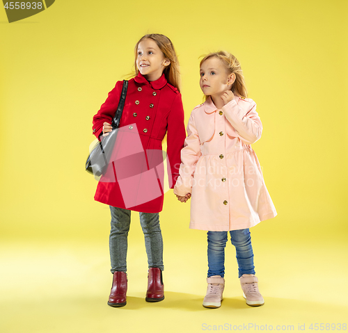 Image of A full length portrait of a bright fashionable girls in a raincoat