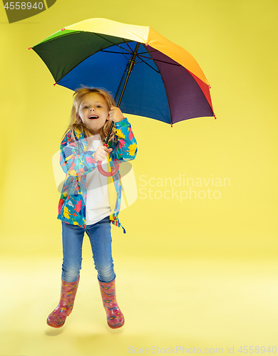 Image of A full length portrait of a bright fashionable girl in a raincoat