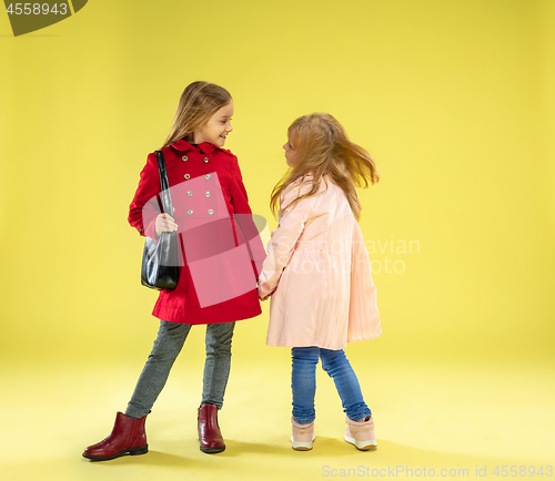 Image of A full length portrait of a bright fashionable girls in a raincoat