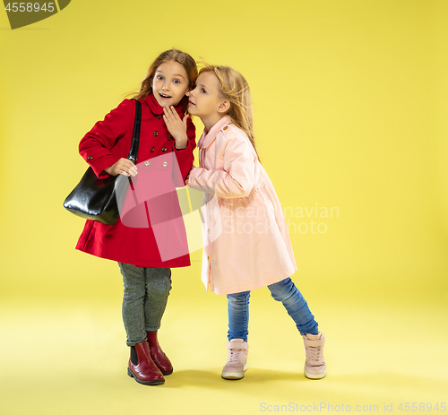 Image of A full length portrait of a bright fashionable girls in a raincoat