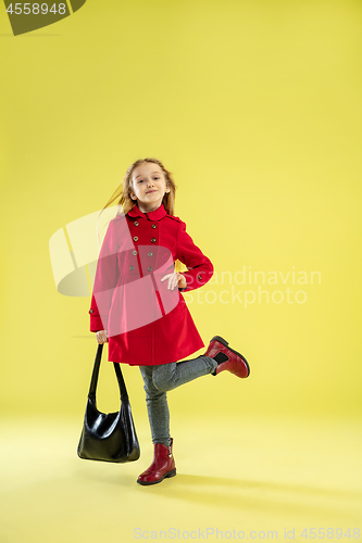 Image of A full length portrait of a bright fashionable girl in a raincoat