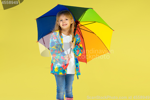 Image of A full length portrait of a bright fashionable girl in a raincoat