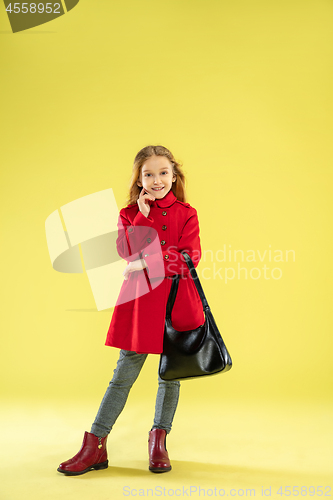 Image of A full length portrait of a bright fashionable girl in a raincoat