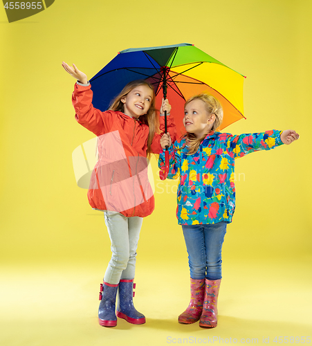 Image of A full length portrait of a bright fashionable girls in a raincoat