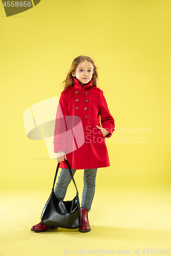 Image of A full length portrait of a bright fashionable girl in a raincoat