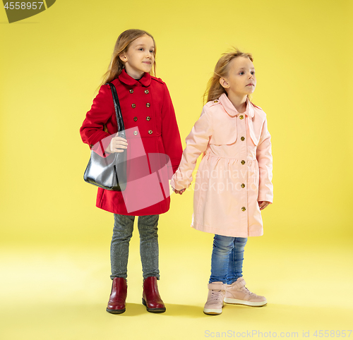 Image of A full length portrait of a bright fashionable girls in a raincoat