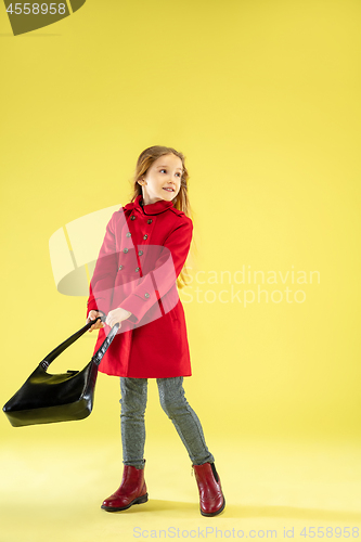 Image of A full length portrait of a bright fashionable girl in a raincoat