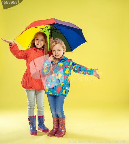 Image of A full length portrait of a bright fashionable girls in a raincoat