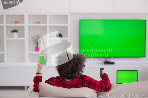 Image of young man in bathrobe enjoying free time