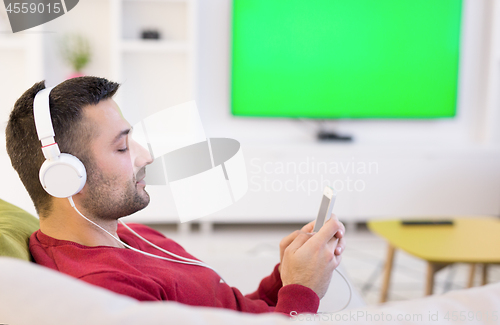 Image of man enjoying music through headphones