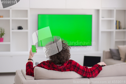 Image of young man in bathrobe enjoying free time