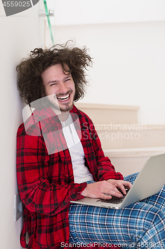 Image of freelancer in bathrobe working from home