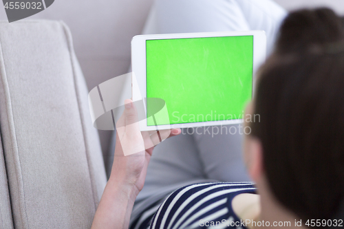 Image of woman on sofa using tablet computer