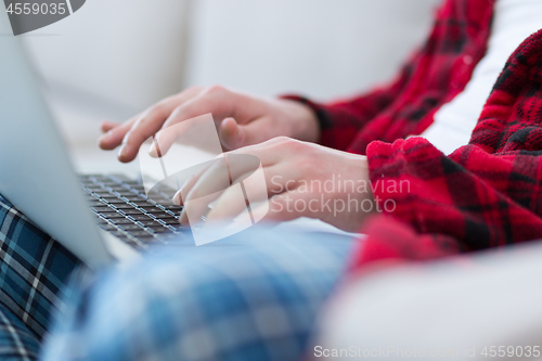 Image of man freelancer in bathrobe working from home