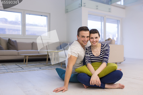 Image of couple sitting on the floor at home